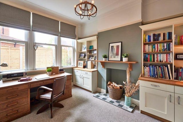 The study at the rear of the house has fitted cupboards and shelving.