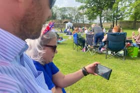 Guy and Natalie Beckett resorted to watching the ceremony on a mobile phone
