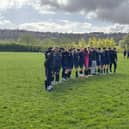 Members of Wakefield AFC Juniors observing a minute's silence for the Wakefield AFC fan who died