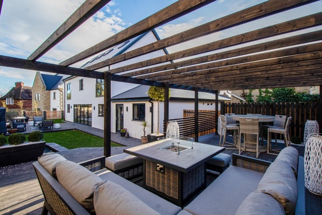 A garden designed for entertaining, with decked and paved patios, and pergola.