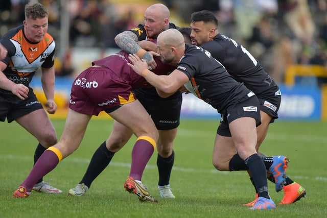 Nathan Massey, Paul McShane and Kenny Edwards combine to halt a Huddersfield Giants player.