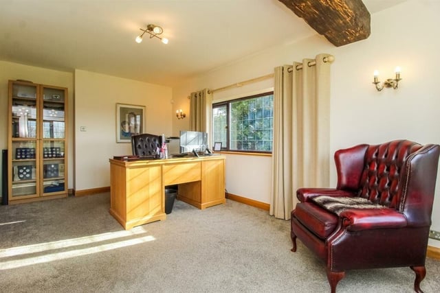 Thius lovely office room features windows to both the rear and side and a heavy wooden beam to the ceiling.