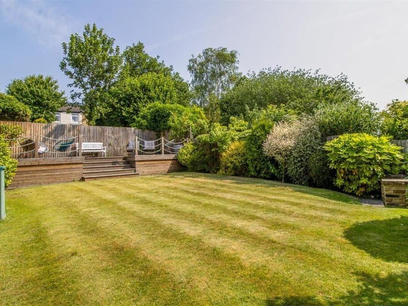 Yorkshire stone steps lead to a lawned garden which is beautifully landscaped with plants and shrubs, and has breathtaking views over Newmillerdam Country Park.