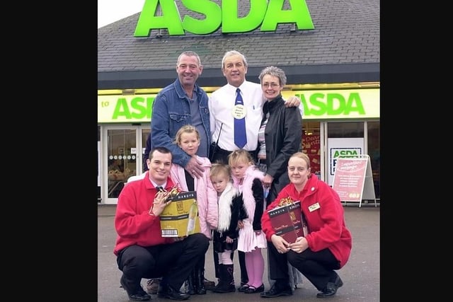 Christmas Colleague presentation at Asda, Durkar in 2004. Picture shows Asda Colleague Frank Pickles with the family that nominated him (through the Express) Mr.& Mrs.Barry & Nanette Swain with their grandchildren Rosie, Ollie and Mia Dickinson. The two 'red coats' are operations manager Dave Ditcher and events co-ordinator Emma Ralton.
