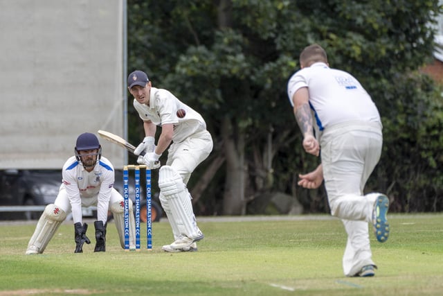 Old Sharlston wicketkeeper Zack Brown watches on as Brent Law faces up.