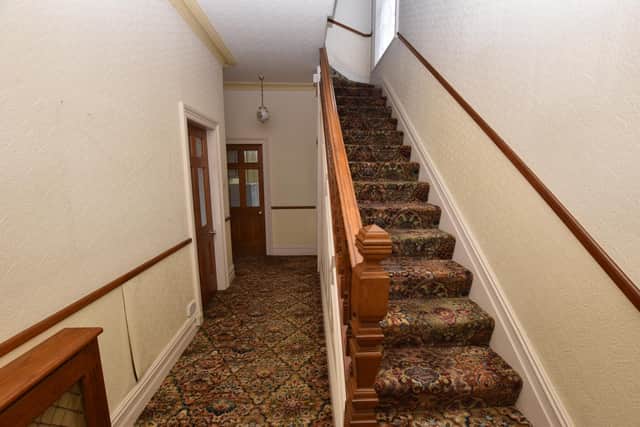 A hallway with stairs leading up.