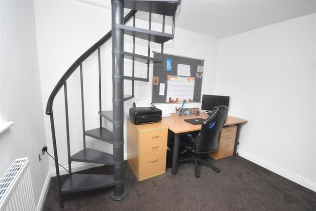 This bedroom with a mezzanine level is currently used as an office below with the bedroom above.