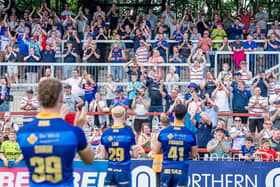 Wakefield Trinity players thank the supporters and the fans respond after their side's first victory of the season over Leeds Rhinos. Picture: Allan McKenzie/SWpix.com