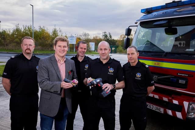 Coun Jack Hemingway pictured with representatives of West Yorkshire Fire Service.