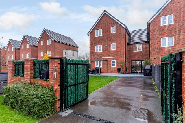 Security gates open to the driveway of the house on this award winning residential development.