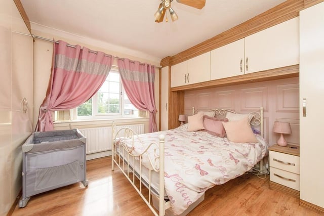 The home's primary bedroom includes overhead fitted wardrobes.