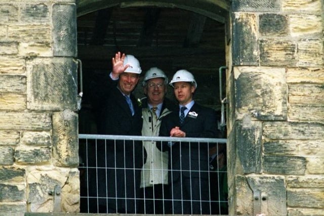 HRH Prince Charles waves from the top floor of the Navigation Warehouse .
