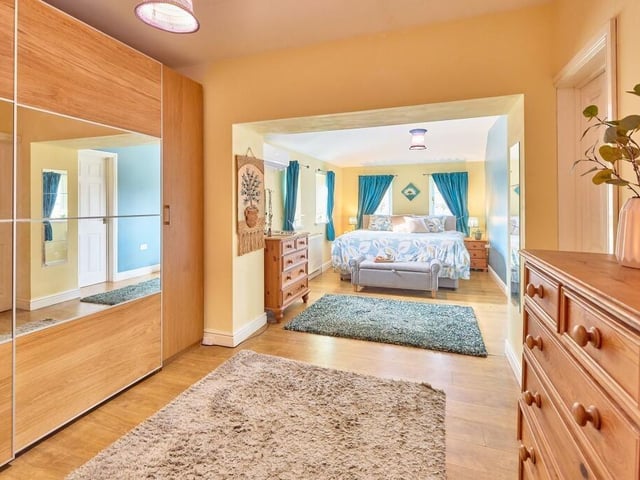 The principal bedroom has four dual-aspect windows, complete with an en suite shower room and additional walk-in wardrobe.