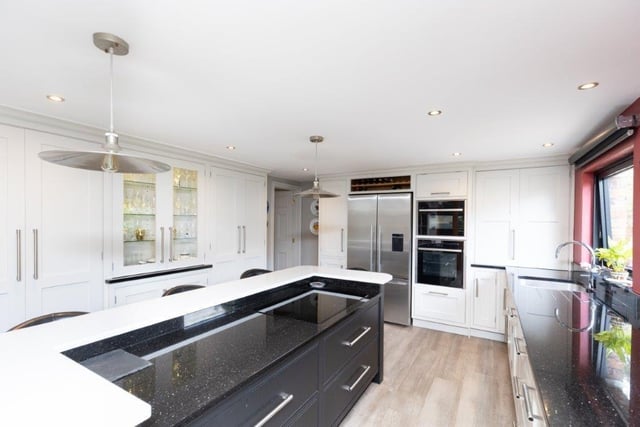 Fitted units and granite worktops, plus a white granite island are among the features of this sleekly styled kitchen.