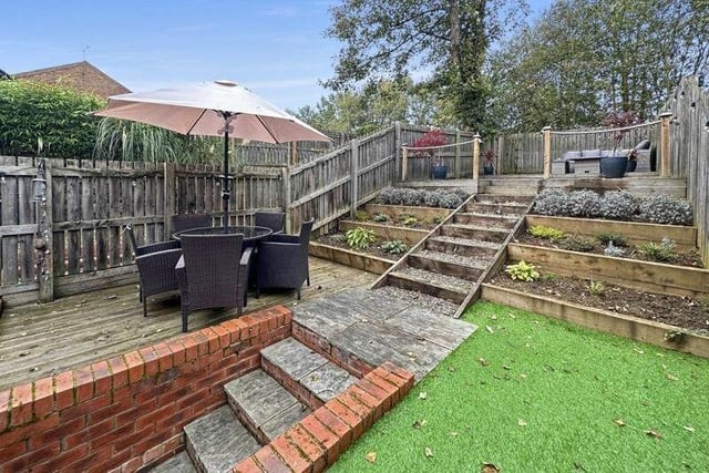 The attractive tiered garden has two seating areas.