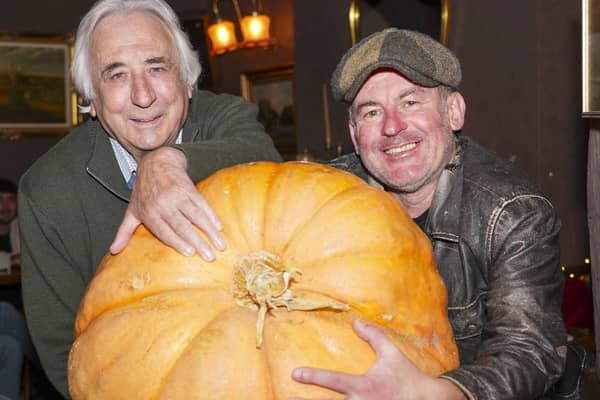 Sean Carter and his fellow allotment holder John Rushton have grown a massive pumpkin which is on displaty in the Robin hood pub in Pontefact. Picture Scott Merrylees