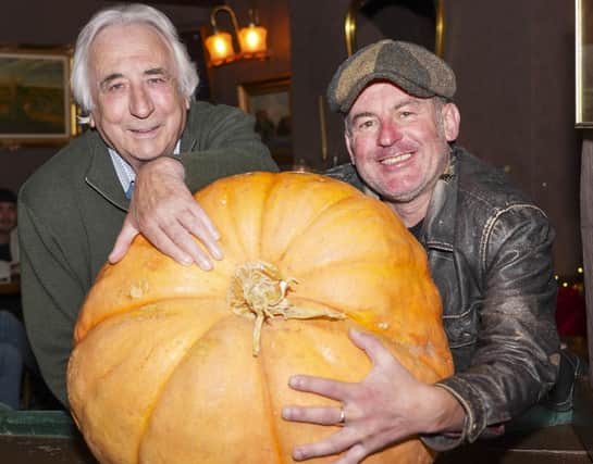 Sean Carter and his fellow allotment holder John Rushton have grown a massive pumpkin which is on displaty in the Robin hood pub in Pontefact. Picture Scott Merrylees