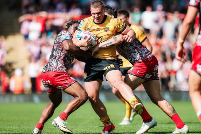Jack Brown is stopped by Leigh's Edwin Ipape and Owen Trout. Picture by Alex Whitehead/SWpix.com