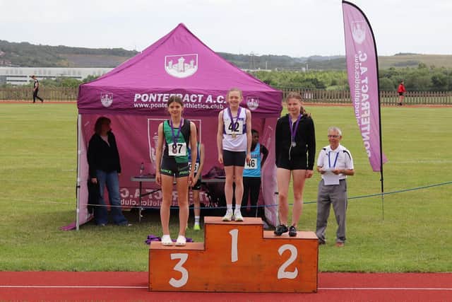 Sienna Lavine at the top of the rostrum after receiving her award for winning the U13 girls 100 metres at the Pontefract Open Meeting.