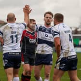 High fiving Brad Day and Ben Reynolds celebrate a Featherstone Rovers try with Greg Minikin. Picture: JLH Photography