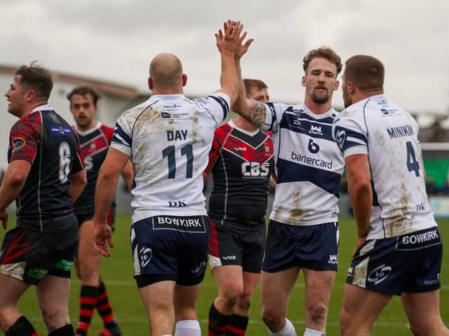 High fiving Brad Day and Ben Reynolds celebrate a Featherstone Rovers try with Greg Minikin. Picture: JLH Photography