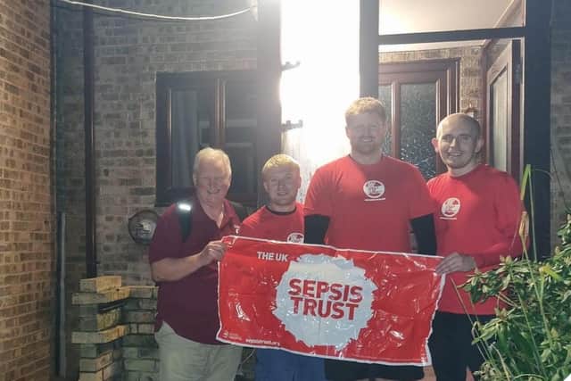 Robert, Jack, George and Joe after completing their sponsored walk for sepsis, despite the extreme weather caused by Storm Babet.