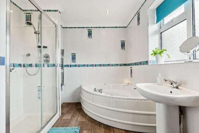 A luxury bathroom with both bath and shower unit.
