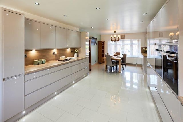 Sleek and spacious, the kitchen has a full range of fitted units with integrated appliances.