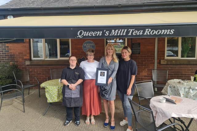 Dana Russell with staff at Queen's Mill Tea Rooms in Castleford