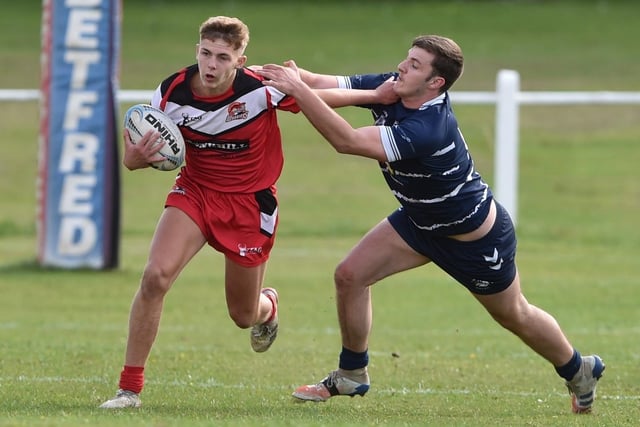 Leyton Davies looks to hand off a Featherstone Lion opponent. Picture: Matthew Merrick
