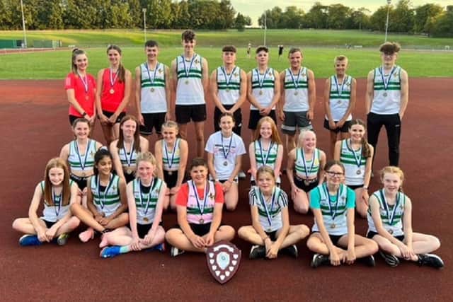 Wakefield Harriers show off the trophy they won by finishing top of the Yorkshire and District Athletics League.