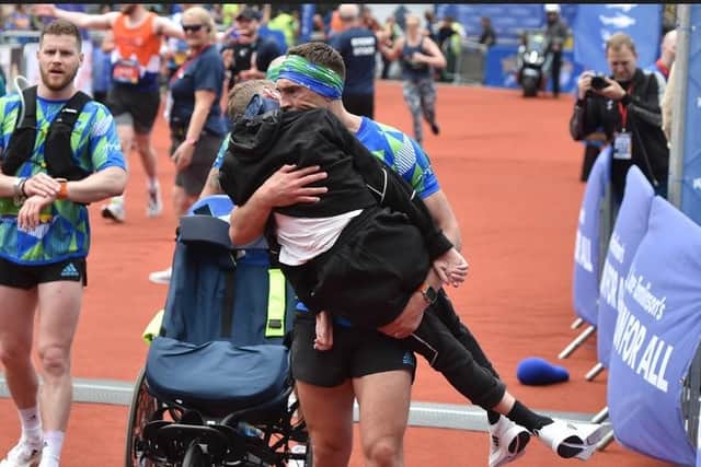 The image of Kevin carrying Rob across the finish line went viral on social media around the world
