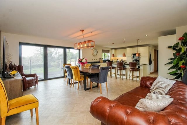 This open plan area forms the practical hub of this lovely family home. There are two windows to the front, a further window to the rear and a triple set of bi-folding doors with encapsulated blinds out to the decked seating area overlooking the gardens.