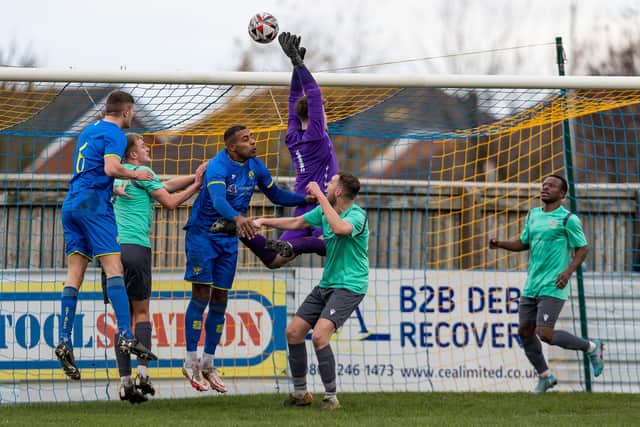 Frickley Athletic goalkeeper Charlie Preston leaps highest to a high ball put into the box by Garforth Town. Picture: John Hobson