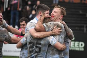 Craig Kopczak celebrates with Featherstone Rovers teammates after scoring a try against Castleford Tigers. Picture: Rob Hare