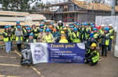 The MND community, including Rob Burrow’s parents Geoff and Irene, Leeds Teaching Hospital’s MND patients and their families celebrate Leeds Hospitals Charity reaching its £6.8million fundraising total before signing the timber frame under construction at the Rob Burrow Centre in Seacroft, Leeds