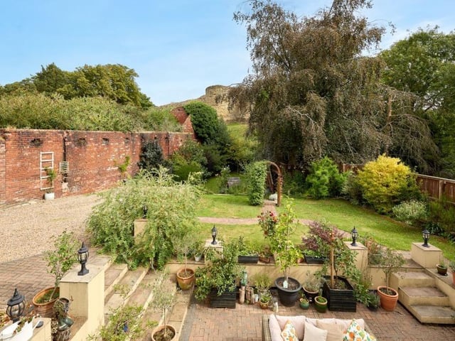 Stretching over 100 feet, the plentiful lawns are a safe and peaceful place to relax and play – with a whimsical treehouse and space for a greenhouse alongside the garden shed.