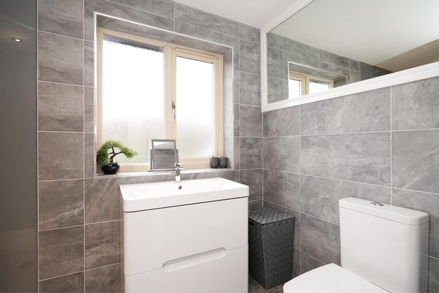 The modern shower room has a three-piece suite.