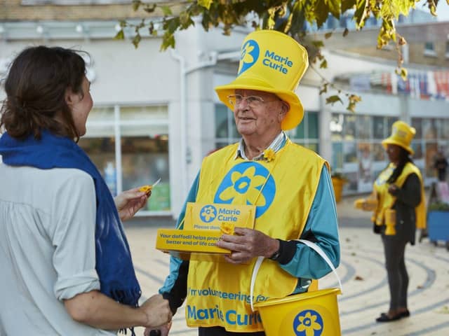 Volunteer at a Marie Curie Great Daffodil Appeal collection raising vital funds for the charity