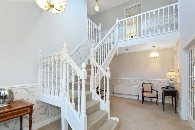 The entrance hall features a beautiful open staircase, two central heating radiators and a small storage room.