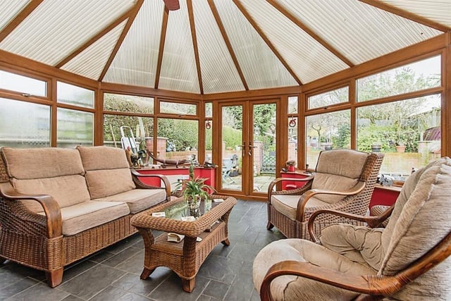 A spacious conservatory has French doors out to the garden.