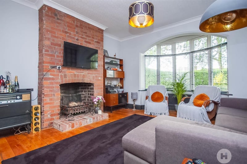 The bay-fronted sitting and family room with feature chimney breast and fireplace.