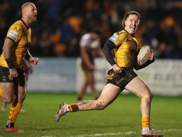Tom Weaver is all smiles on his way over for a try.
