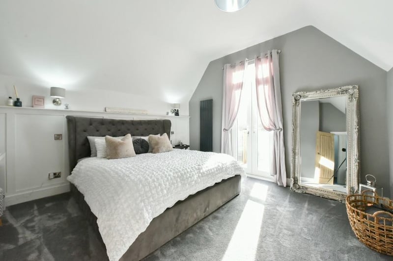The master bedroom features an en suite and balcony, which looks over the rear garden.