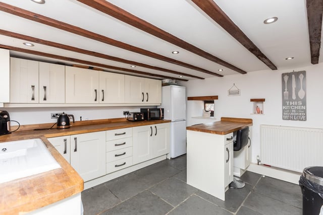 The good size fitted kitchen has a full range of units, with a matching breakfast bar.