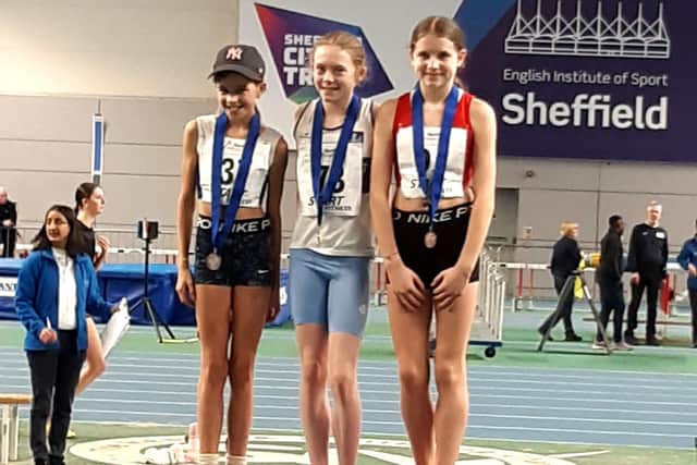 Sienna Lavine (centre) with her gold medal won in the Northern Indoor Championships.