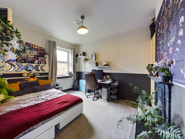Three of five bedrooms have fireplaces. This double room has ample space for a study area.