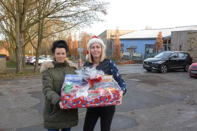 Claire Tyndall from Sandal Castle School with single mother of four Jade and her hamper donated by an Express reader
