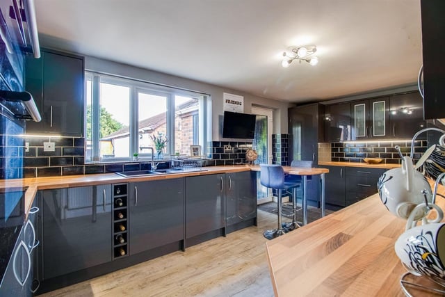 This stylish kitchen with breakfast bar has fitted units and appliances.