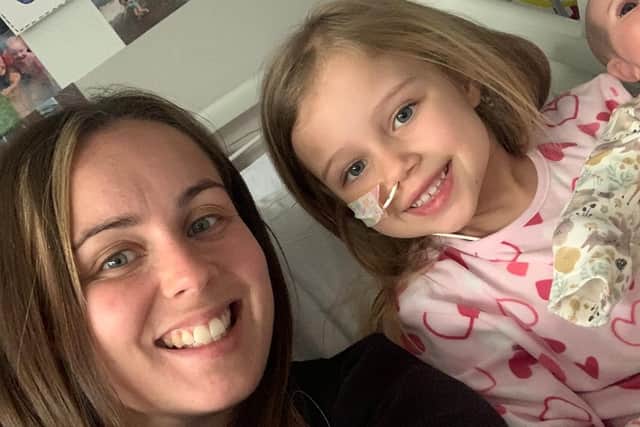 Pictured Penny Barraclough and mum Jodie Mangham. An adorable young girl with a rare genetic condition has gone viral on social media after recording cute dance routines with her nurses. See SWNS story SWLNdance. Penny Barraclough’s incredible moves and bubbly personality led millions to watch her Tik Tok clips - as she underwent a stem cell bone marrow transplant in hospital. The six-year-old was diagnosed with congenital amegakaryocytic thrombocytopenia (CAMT),  which left her “head to toe” in bruises and stopped her blood from clotting. And after she suffered bone marrow failure, doctors first gave her chemotherapy before she had the transplant operation at Sheffield Children's hospital in September. But fearless Penny didn’t let the dangerous illness ruin her fun during her six weeks on the ward, and instead recorded videos that won her admirers from as far as Australia. And one of her clips, where she performed a catchy routine with a staff nurse, even racked up nearly eight million views on the social media app alone. Penny’s mum Jodie Mangham, 30, who helped her record the videos, said the cheeky little girl had turned a “heart-breaking” situation into a "positive" one. 